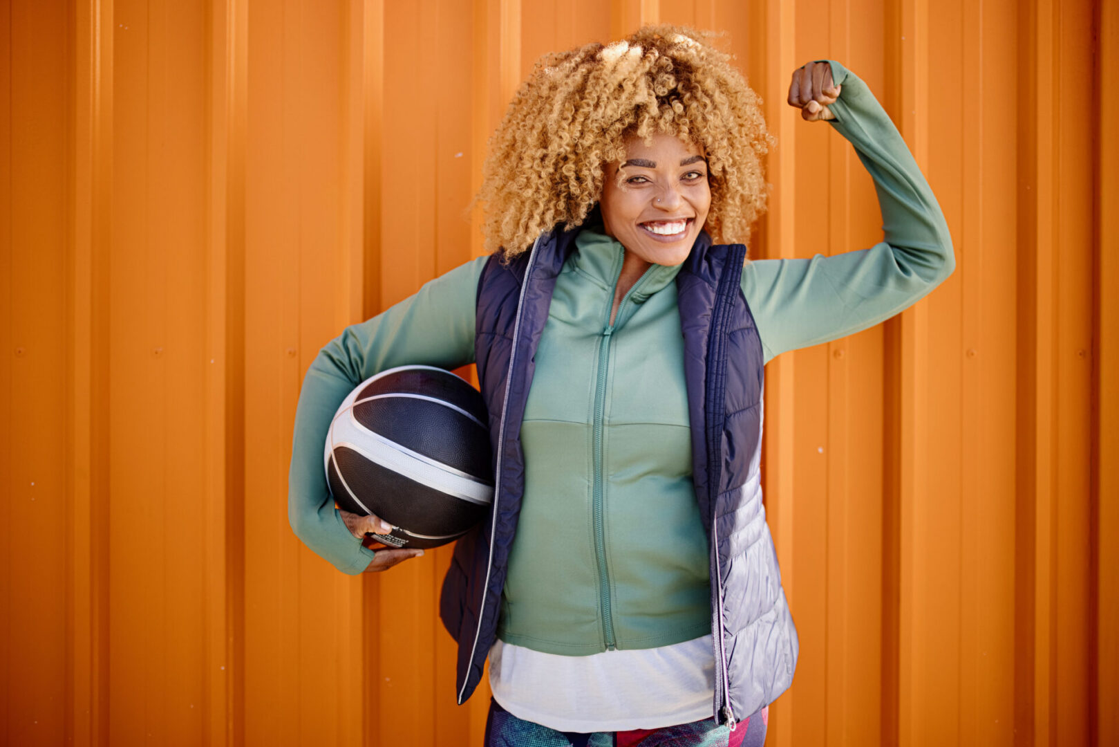 Portrait of a middle aged woman against orange background